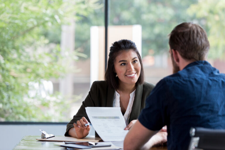 New Omni Bank Relationship Banker discussing C&I loan options with a client in a friendly and professional setting.