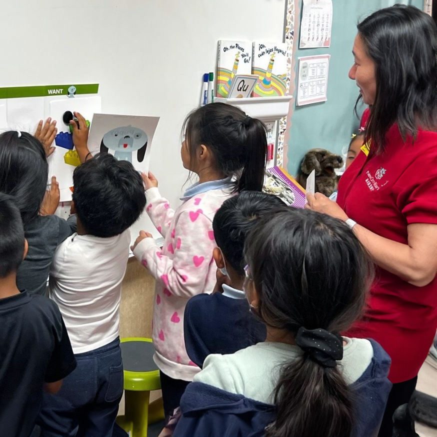 Children engaging in a financial literacy workshop led by a New Omni Bank team member.