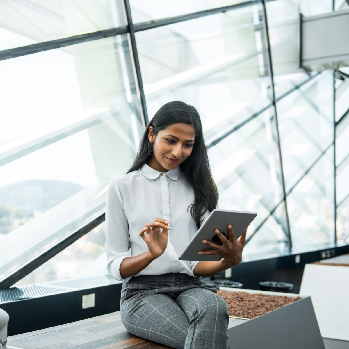 A businesswoman using a digital tablet in her office.