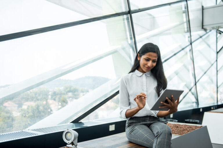 A businesswoman using a digital tablet in the office.