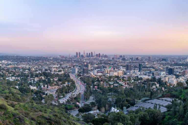 Panoramic view of Los Angeles skyline at dusk, showcasing the city's vibrant business district and residential areas.