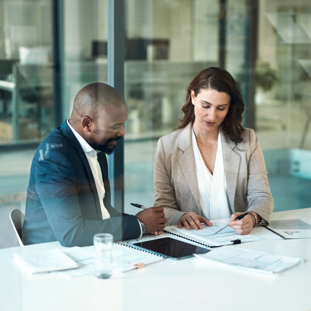 Two businesspeople working on a business proposal for applying for a C&I loan.