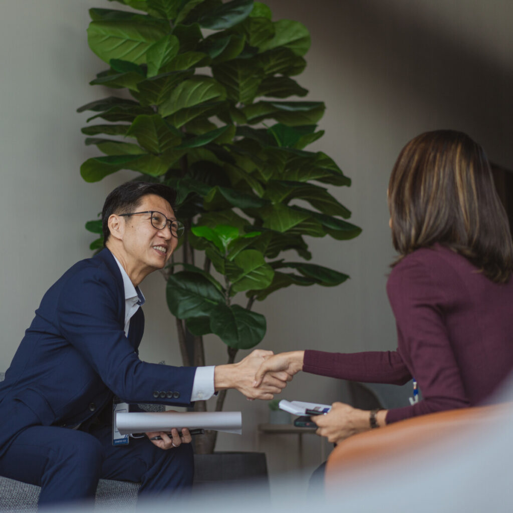 An Asianbanker listening to the mortgage aspiration of her clients in an office.