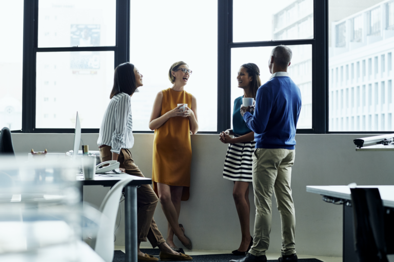 New Omni Bank's diverse team engaging in productive discussions.