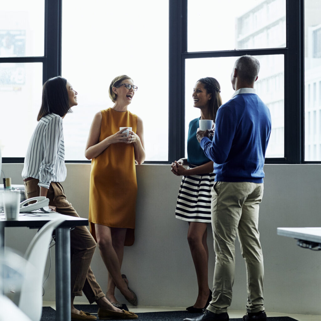 New Omni Bank's diverse team engaging in productive discussions.