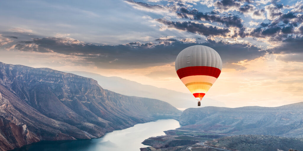 New Omni Bank: Where every financial journey begins with trust, pictured through a flying balloon against sunrise.