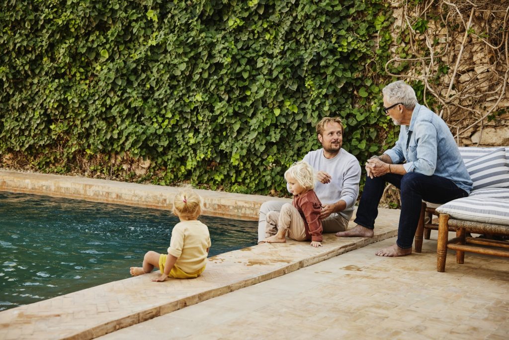 A family spending quality time together at the poolside in their home