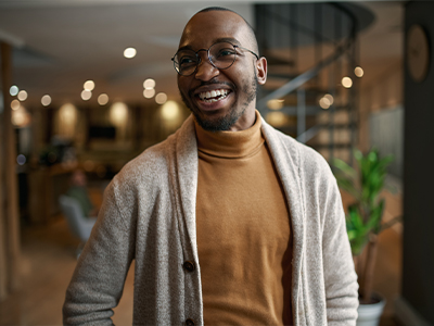 A joyful African entrepreneur laughing with confidence, exuding positivity and success