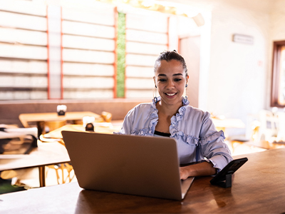 A freelancer working on her mortgage documents with her laptop at home