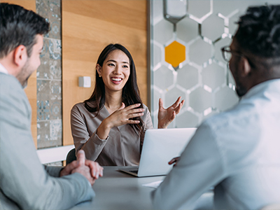 A New Omni Bank banker explaining the HELOC programs to her clients in a meeting room