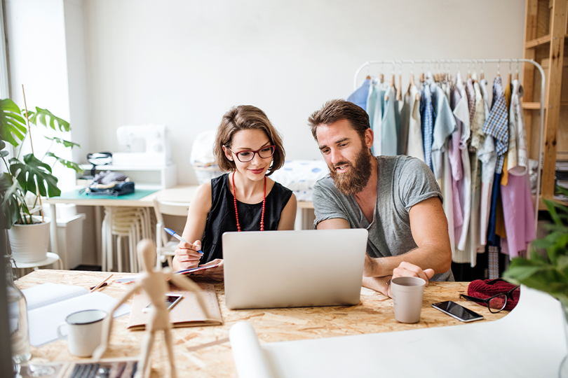 Young couple managing their money market account online from their home office