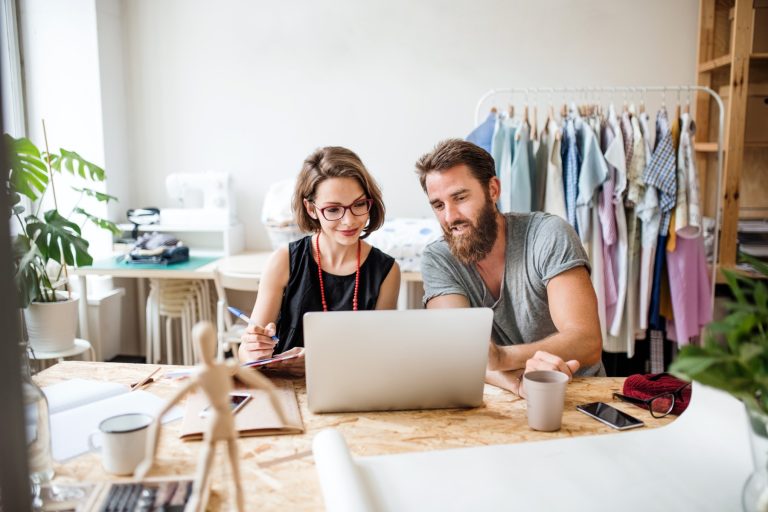 Young couple managing their money market account online from their home office