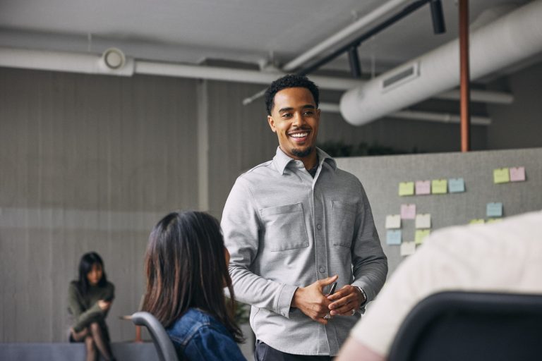 A confident professional leading a meeting in a startup office, symbolizing financial strategy