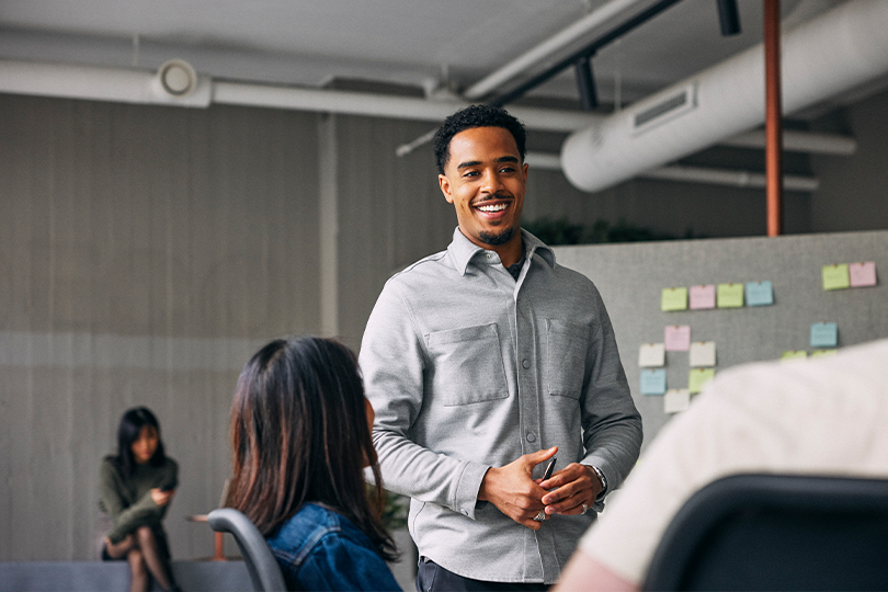 A confident professional leading a meeting in a startup office, symbolizing financial strategy
