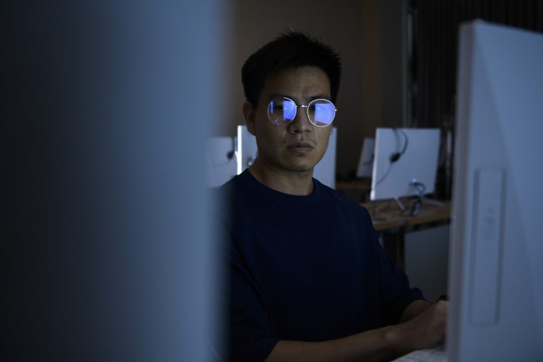 Computer hacker stealing information from small businesses with his computer