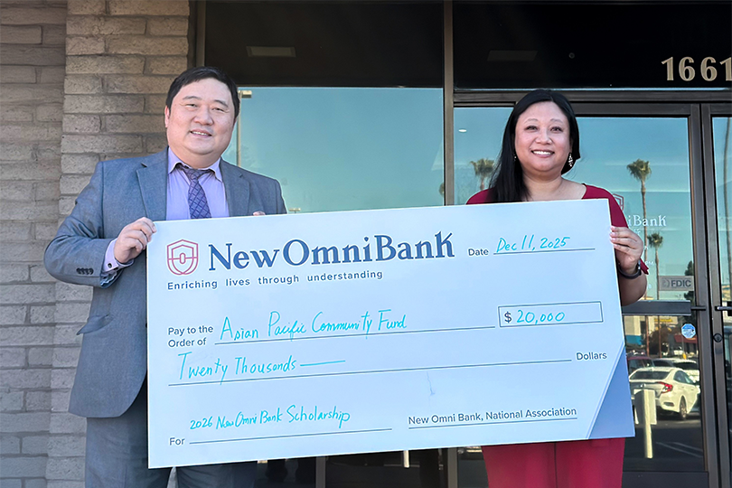 Leon Sung, Managing Director and CRA Officer of New Omni Bank, presents a $20,000 donation check to Karen Fan, Operations Manager of the Asian Pacific Community Fund